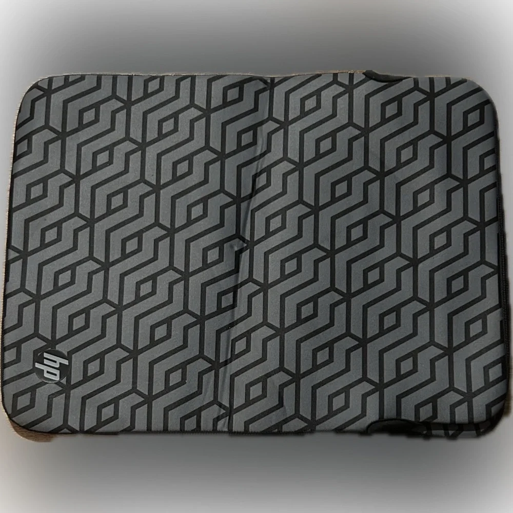 HP Reversible 14.1-inch Laptop Sleeve with a grey geometric pattern